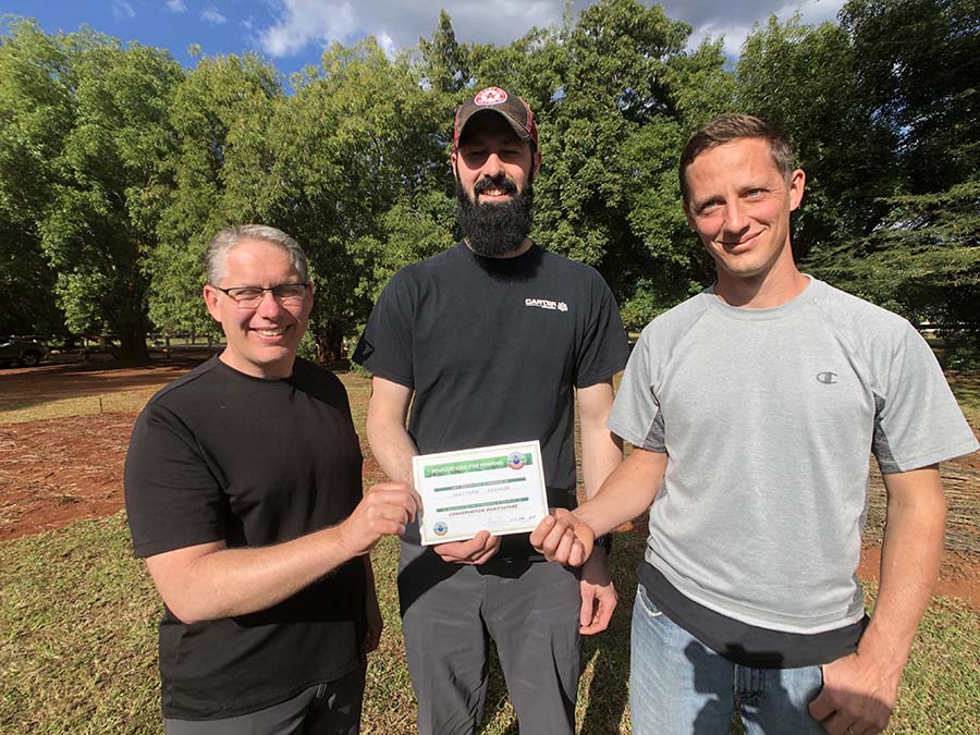 three men with training certificate